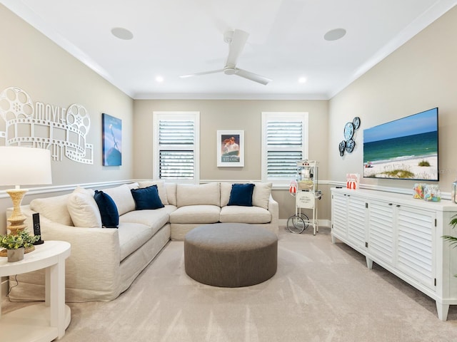 living room with ceiling fan, crown molding, and light carpet