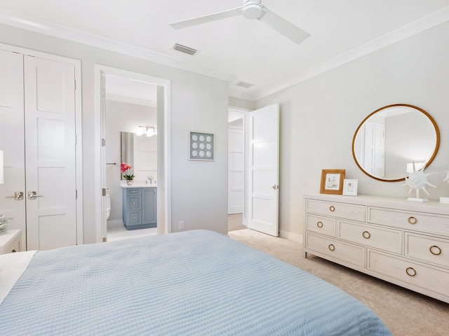 bedroom featuring light carpet, ensuite bathroom, ceiling fan, crown molding, and a closet