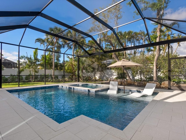 view of swimming pool with an in ground hot tub, a patio, and glass enclosure