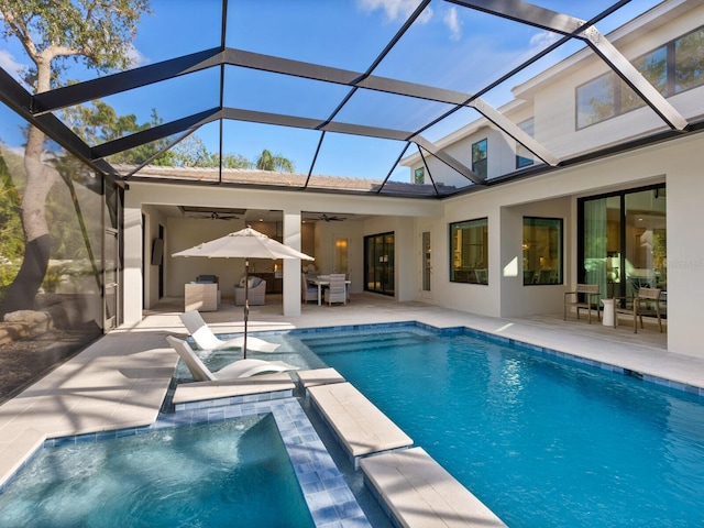 view of pool featuring glass enclosure, ceiling fan, and a patio