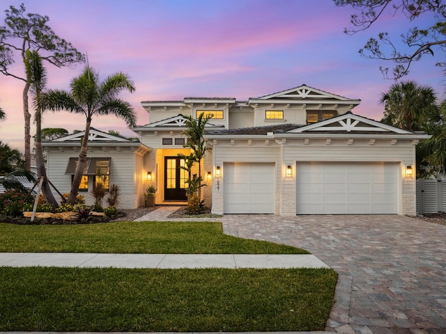 view of front of house featuring a lawn and a garage