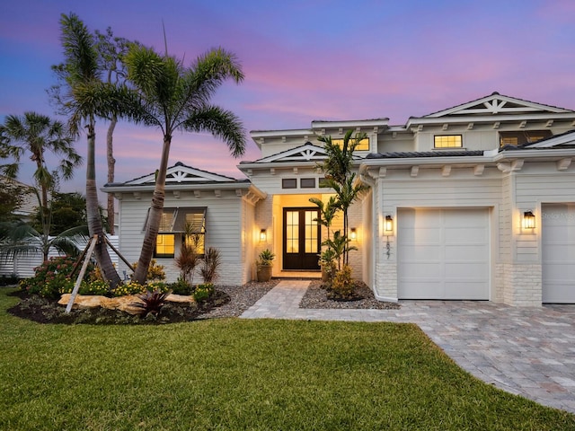 view of front of property with french doors and a yard