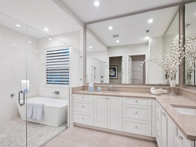 bathroom featuring vanity, tile walls, and independent shower and bath