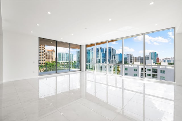 empty room with light tile patterned floors and floor to ceiling windows