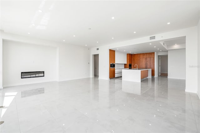 unfurnished living room with sink