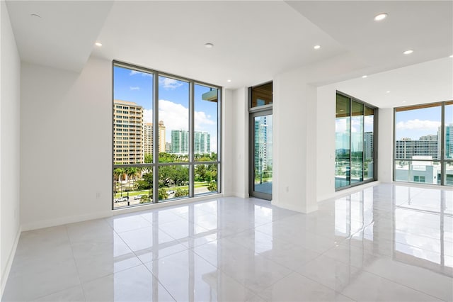 unfurnished room with plenty of natural light and a wall of windows