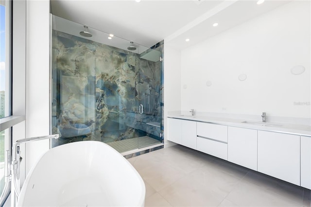 bathroom featuring tile patterned floors, vanity, and independent shower and bath