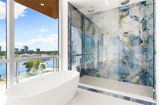 bathroom with a water view and plus walk in shower