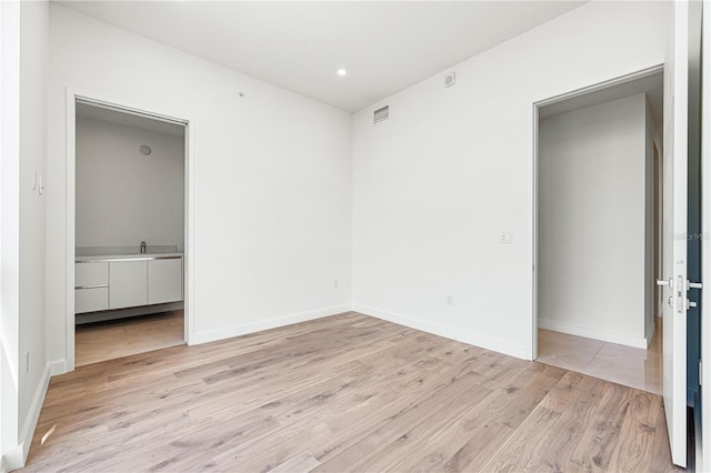 unfurnished bedroom with light wood-type flooring