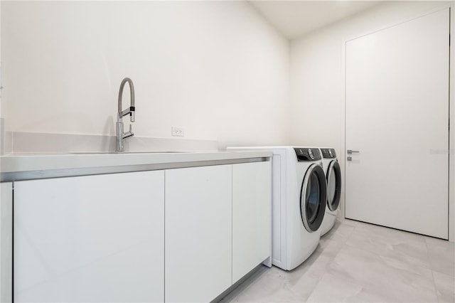 laundry area with cabinets, sink, and independent washer and dryer