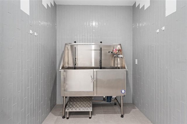 miscellaneous room featuring tile walls and tile patterned flooring