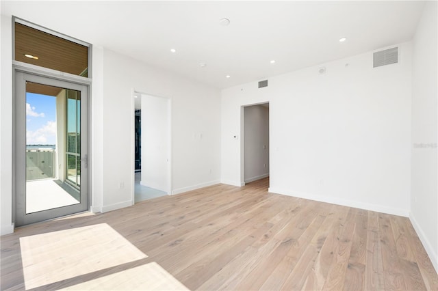 empty room with light hardwood / wood-style flooring