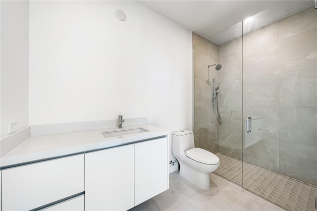 bathroom featuring vanity, toilet, and a shower with door