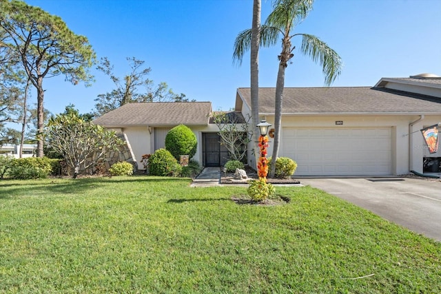 ranch-style house featuring a front lawn and a garage