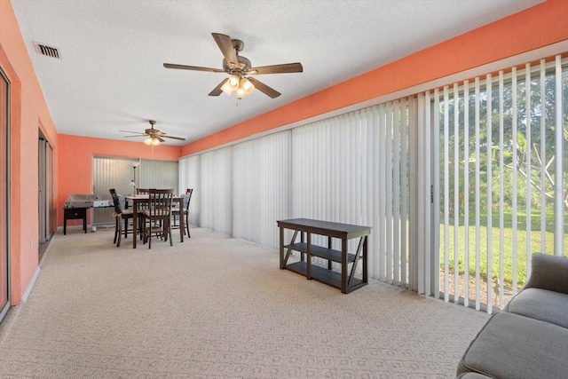 sunroom featuring ceiling fan