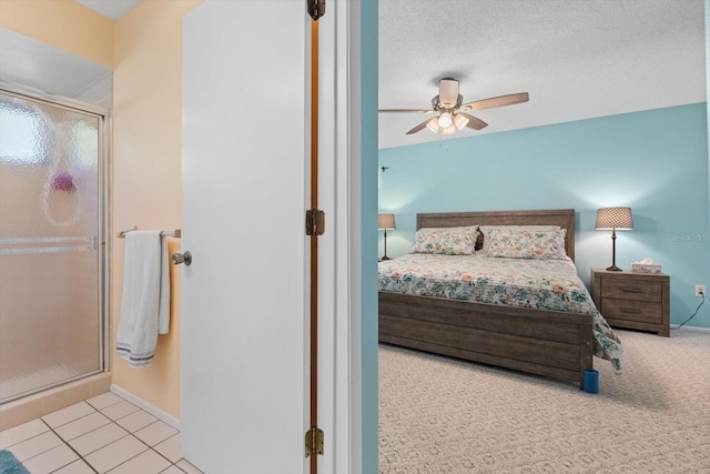 bedroom with a textured ceiling, ceiling fan, and light tile patterned flooring