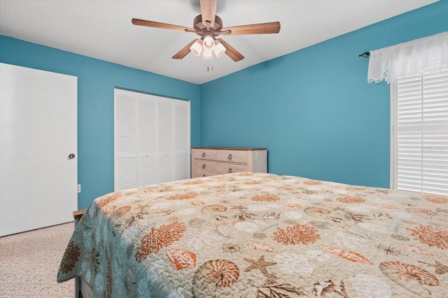 bedroom with carpet floors, ceiling fan, and a closet