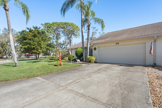 ranch-style home with a front yard and a garage