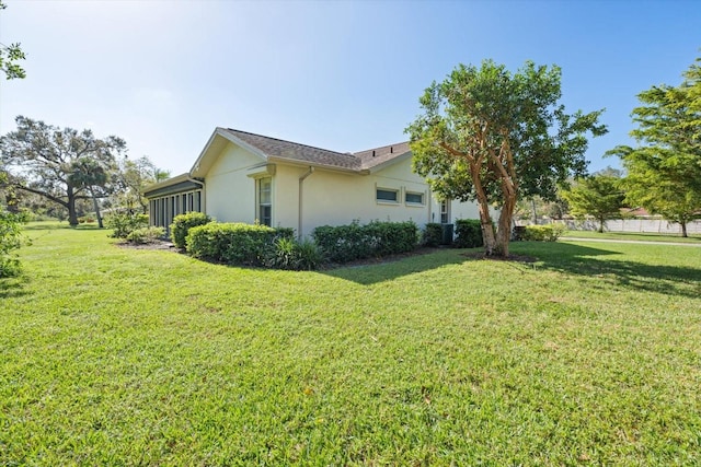 view of home's exterior with a yard