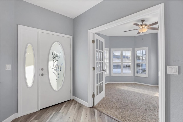 entrance foyer featuring ceiling fan and light colored carpet