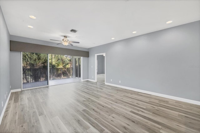 spare room with ceiling fan and light wood-type flooring