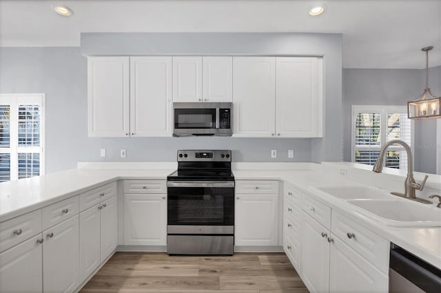 kitchen with white cabinetry, sink, and appliances with stainless steel finishes