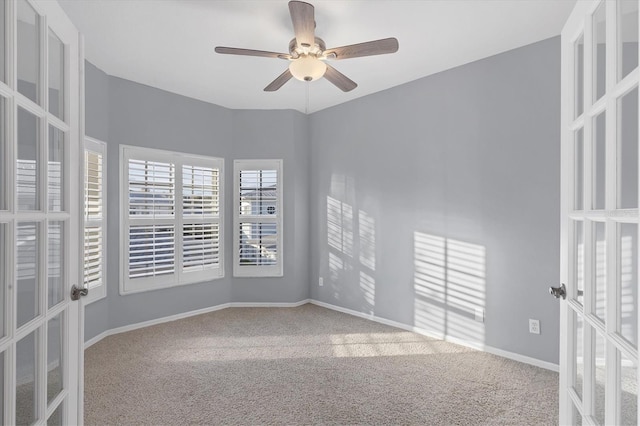 carpeted spare room with french doors and ceiling fan