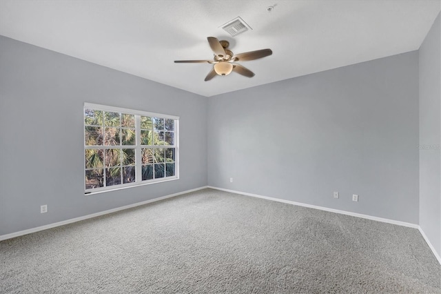 empty room featuring ceiling fan and carpet