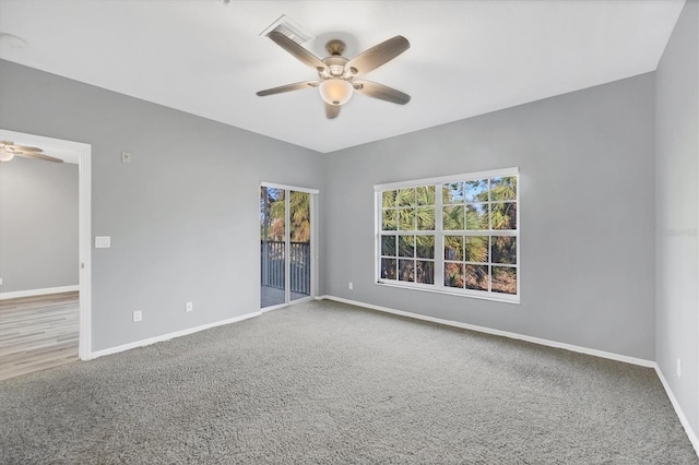 empty room with ceiling fan and carpet floors