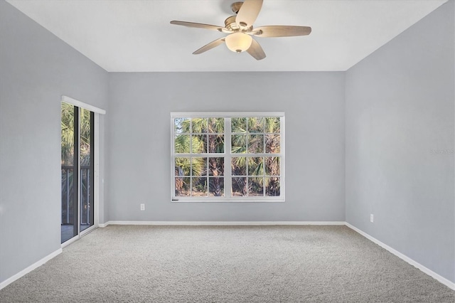 carpeted empty room featuring ceiling fan