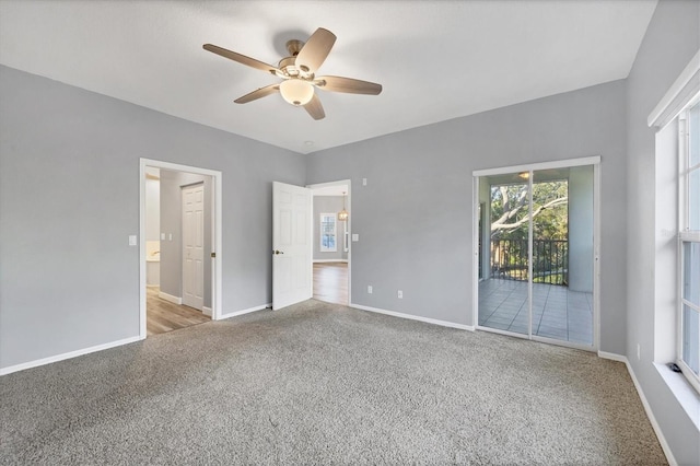 unfurnished bedroom featuring access to outside, ceiling fan, and light colored carpet