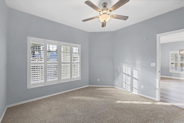 spare room featuring ceiling fan and light colored carpet