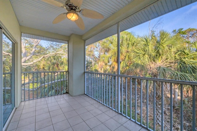 unfurnished sunroom featuring ceiling fan