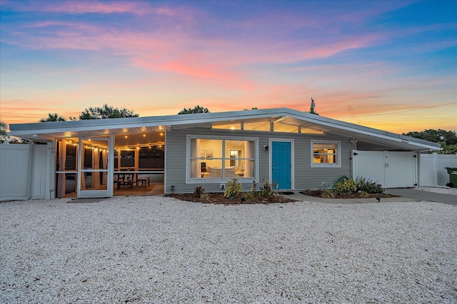 view of back house at dusk