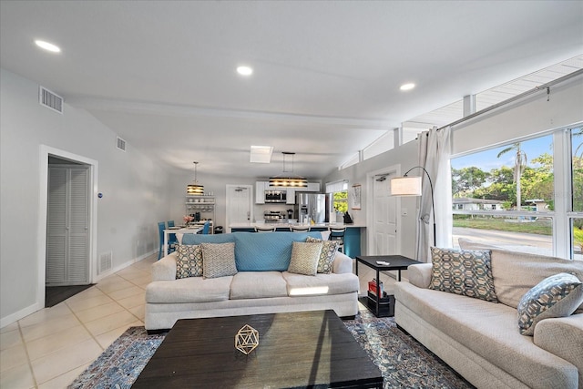 living room featuring light tile patterned floors and vaulted ceiling