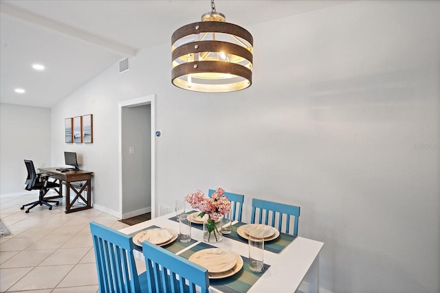 dining area with light tile patterned floors and vaulted ceiling with beams