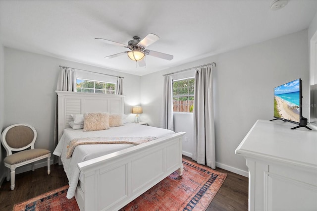 bedroom with dark hardwood / wood-style flooring, multiple windows, and ceiling fan