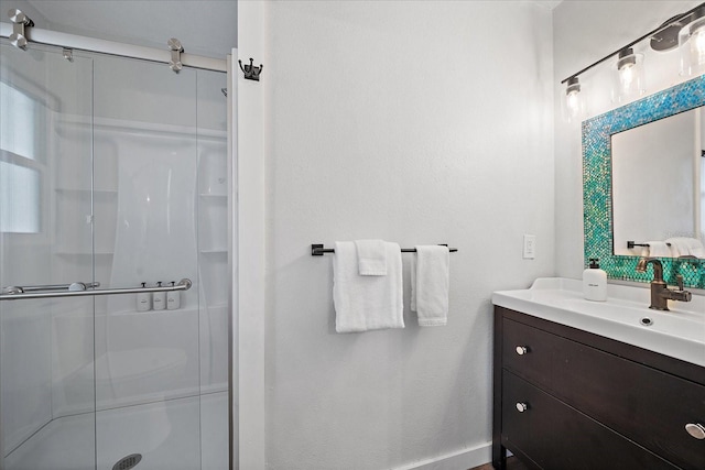 bathroom featuring vanity and a shower with shower door