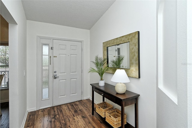 entrance foyer featuring dark hardwood / wood-style flooring and a textured ceiling