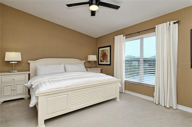 carpeted bedroom with vaulted ceiling and ceiling fan