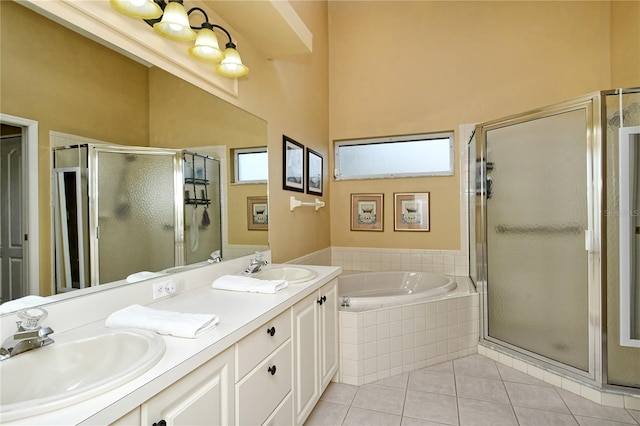 bathroom featuring a wealth of natural light, vanity, plus walk in shower, and tile patterned flooring