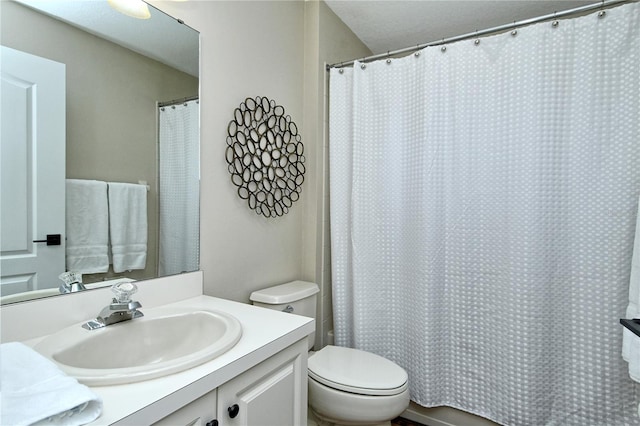 bathroom with toilet and vanity