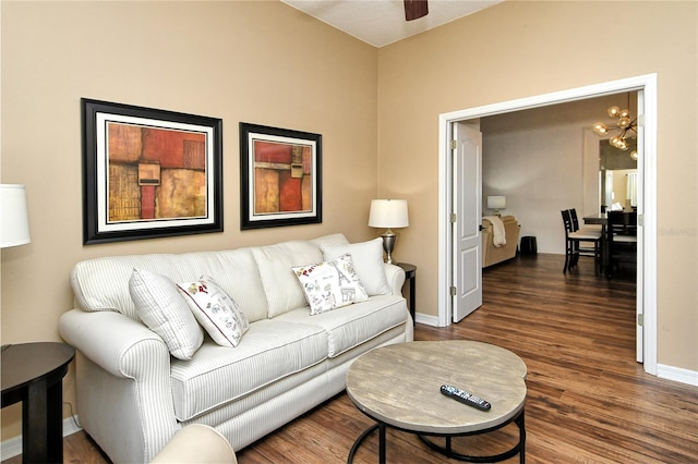 living room featuring dark wood-type flooring and ceiling fan