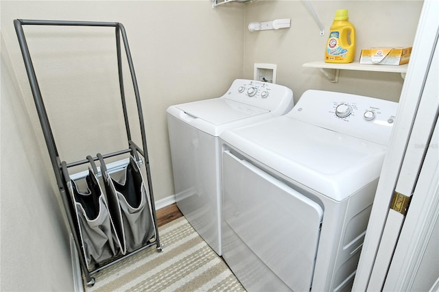 clothes washing area featuring independent washer and dryer