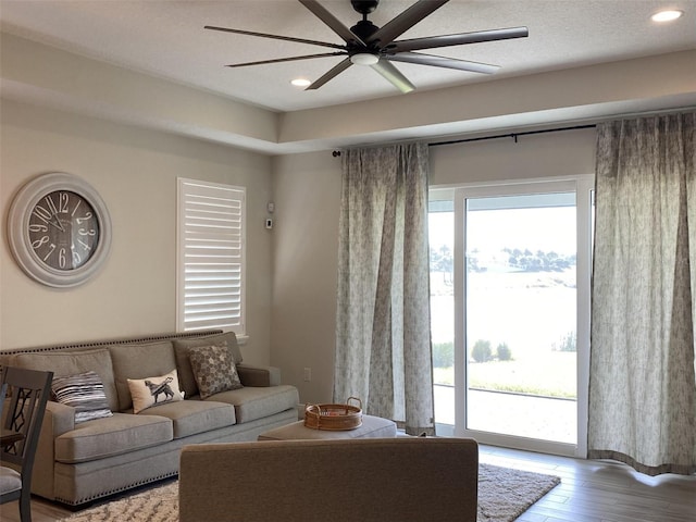 living room with hardwood / wood-style floors and ceiling fan