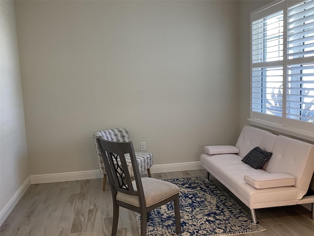 sitting room with wood-type flooring