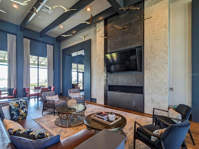 living room with hardwood / wood-style floors and beam ceiling