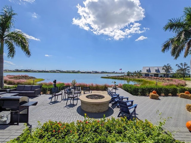 view of patio / terrace featuring a water view and an outdoor fire pit