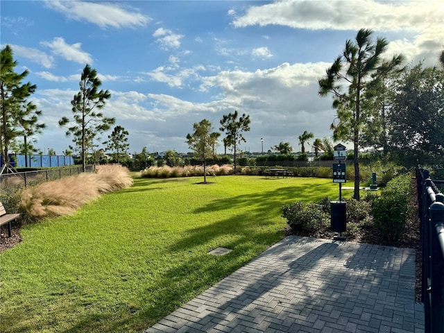 view of home's community with a yard and a patio