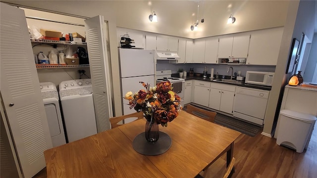 kitchen with white cabinets, white appliances, dark wood-type flooring, and washing machine and clothes dryer